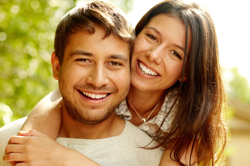 Dental Patients Smiling With Well Cared For Dental Implants In Cambridge, OH