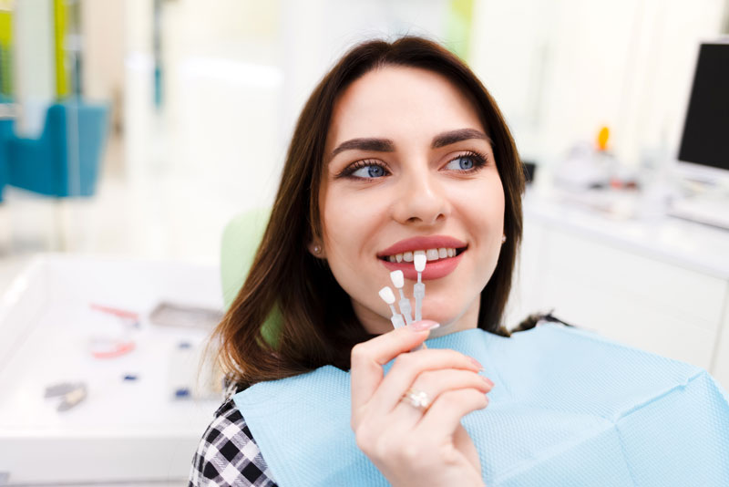 dental patient receiving teeth whitening treatment using dental veneers.