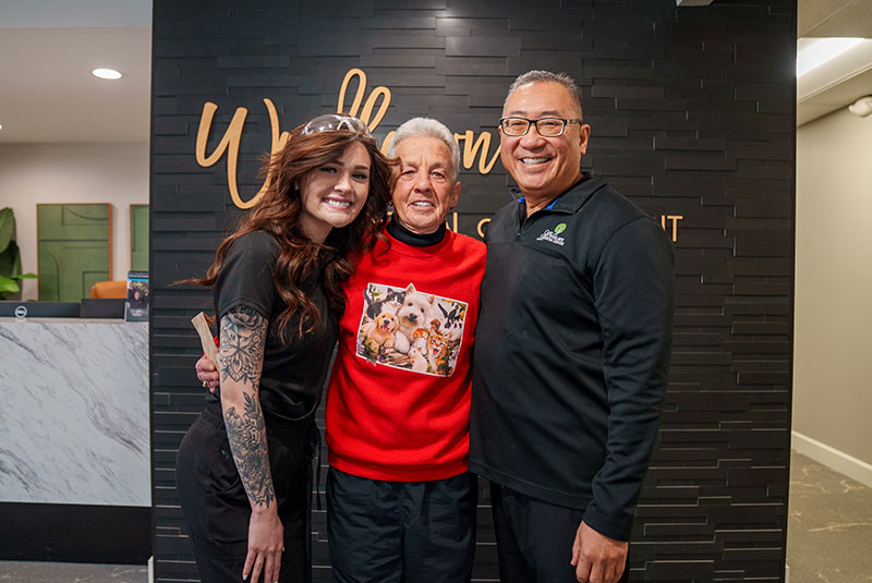 Doctor smiling with patient and team member