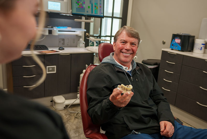 Patient holding model of full arch implants