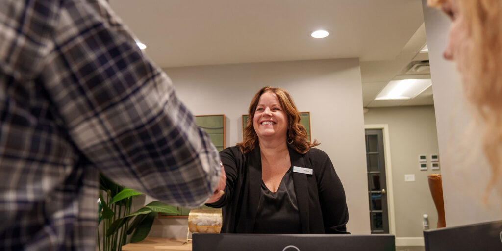 Team member greeting Paitent into office